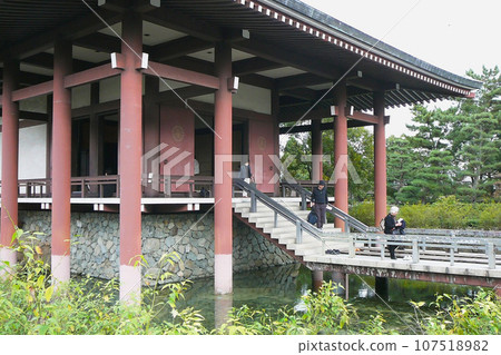 Nara Prefecture/Chuguji Temple's main hall and tourists surrounded by a pond Nara Prefecture/Chuguji Temple's main hall and tourists surrounded by a pond 107518982
