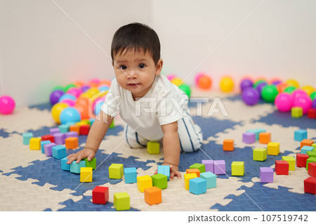infant baby playing wooden block toy in playpen infant baby playing wooden block toy in playpen 107519742