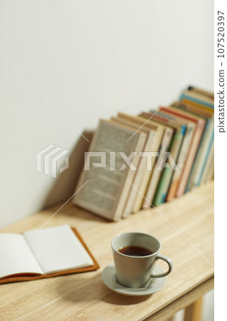 A comfortable room where warm afternoon sunlight comes in through a window with a view of tree leaves. 107520397