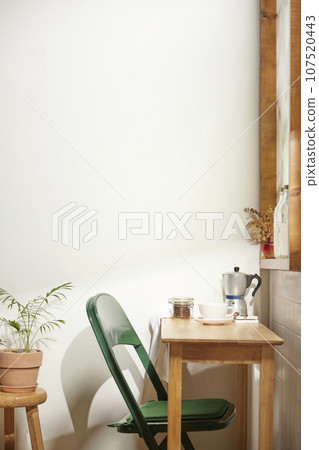 A comfortable room where warm afternoon sunlight comes in through a window with a view of tree leaves. A comfortable room where warm afternoon sunlight comes in through a window with a view of tree leaves. 107520443
