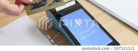 Woman puts card to terminal trying to pay for services 107521322