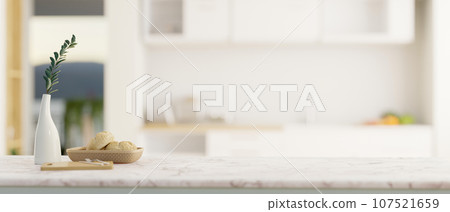 Empty mockup space on a luxury white marble kitchen tabletop in a modern white kitchen. Empty mockup space on a luxury white marble kitchen tabletop in a modern white kitchen. 107521659