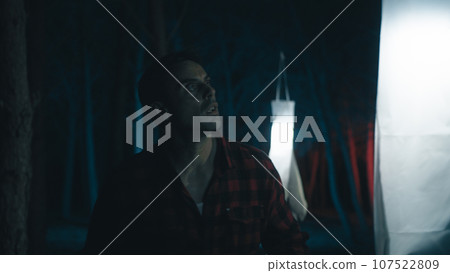 Bright ghosts illuminate man in the forest Bright ghosts illuminate man in the forest 107522809