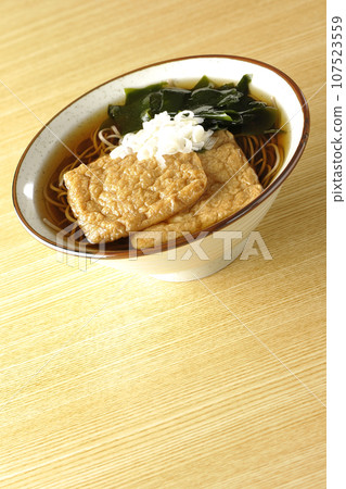 Kitsune soba with two pieces of fried tofu, seaweed, and green onion Kitsune soba with two pieces of fried tofu, seaweed, and green onion 107523559