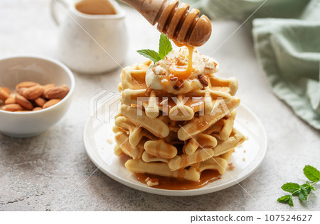 Belgian waffles with fruit, bananas and honey. Homemade baking. Belgian waffles with fruit, bananas and honey. Homemade baking. 107524627