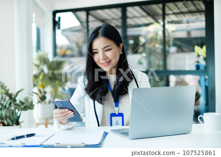 Asian businesswoman calculate financial graphs showing results about their investments, planning successful business growth process Asian businesswoman calculate financial graphs showing results about their investments, planning successful business growth process 107525861