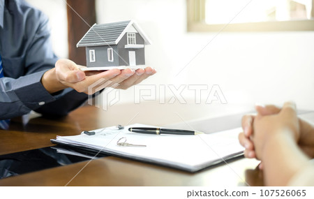 The real estate agent gives the house to a new owner's client after completing the signing of the lease and formally completing home insurance. Rental and insurance concepts The real estate agent gives the house to a new owner's client after completing the signing of the lease and formally completing home insurance. Rental and insurance concepts 107526065