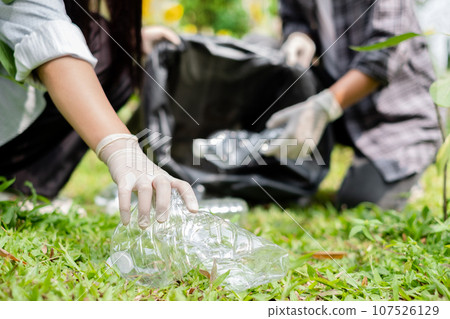 garbage collection, volunteer team picking up plastic bottles, putting garbage in black garbage bags to clean up at parks, avoiding pollution, and being friendly to the environment and ecosystem garbage collection, volunteer team picking up plastic bottles, putting garbage in black garbage bags to clean up at parks, avoiding pollution, and being friendly to the environment and ecosystem 107526129