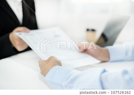 Business people hold a resume and talk to job applicants for job interviews about careers and Their personal history in the company. Recruitment concepts Business people hold a resume and talk to job applicants for job interviews about careers and Their personal history in the company. Recruitment concepts 107526162