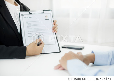 Business people hold a resume and talk to job applicants for job interviews about careers and Their personal history in the company. Recruitment concepts 107526163