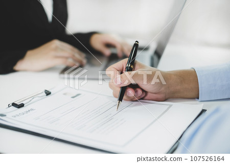 Business people hold a resume and talk to job applicants for job interviews about careers and Their personal history in the company. Recruitment concepts Business people hold a resume and talk to job applicants for job interviews about careers and Their personal history in the company. Recruitment concepts 107526164