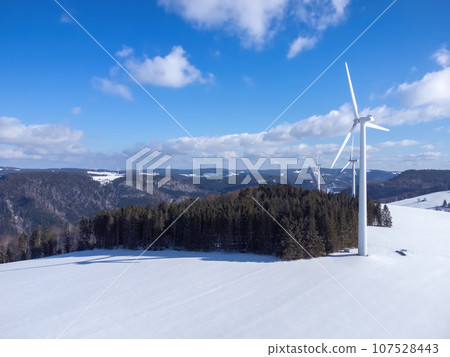 Black Forest with wind energy in snowy winter with space for your content Black Forest with wind energy in snowy winter with space for your content 107528443