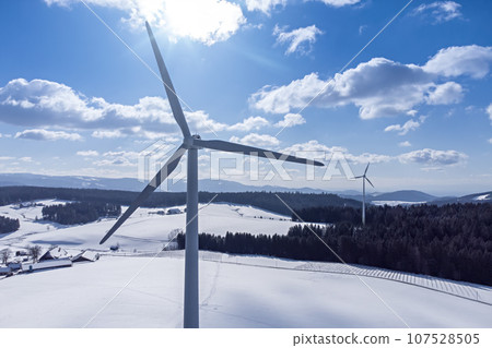 Black Forest with wind energy in snowy winter with space for your content 107528505