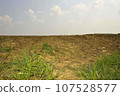 Arable soil and field in spring 107528577