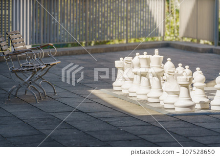 chess game outdoors with chairs chess game outdoors with chairs 107528650