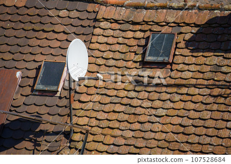 old roof with satellite dish old roof with satellite dish 107528684