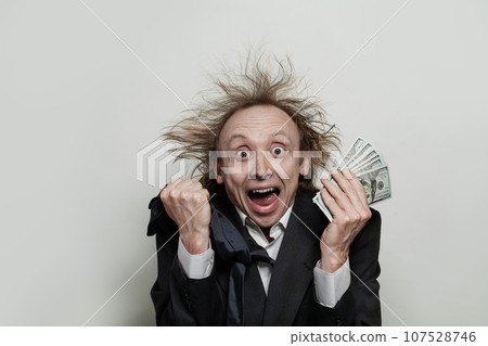 Funny excited businessman with open mouth holding us dollar money on white background 107528746