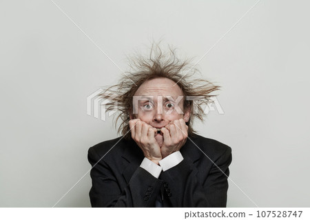 Nervous worryed businessman on white background, studio portrait Nervous worryed businessman on white background, studio portrait 107528747