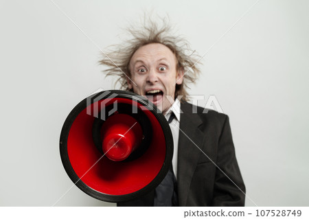 Megaphone loudspeaker in hand of funny mad businessman on white background 107528749
