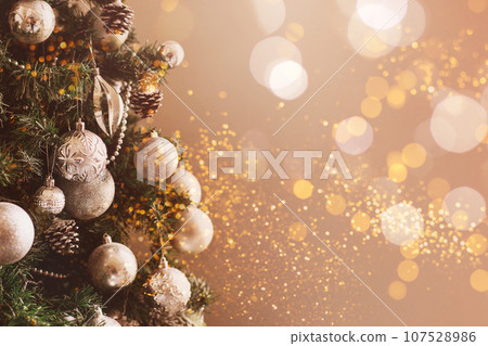 Silver Christmas balls on a fir branch. 107528986
