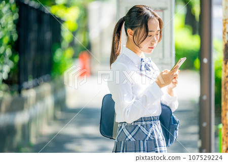 High school girl operating a smartphone 107529224