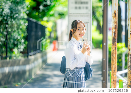 High school girl operating a smartphone High school girl operating a smartphone 107529226
