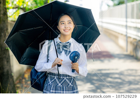 High school girl holding a parasol High school girl holding a parasol 107529229