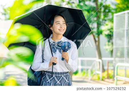 High school girl holding a parasol High school girl holding a parasol 107529232