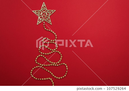 Christmas tree yellow garland on color background 107529264