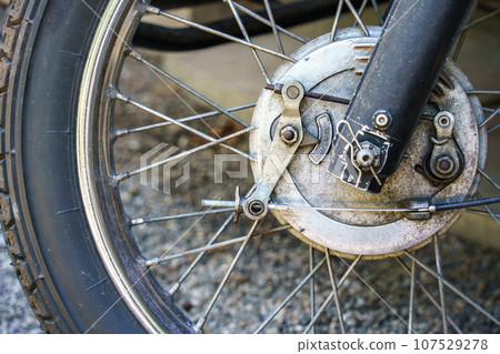 old motorcycle front wheel detail old motorcycle front wheel detail 107529278