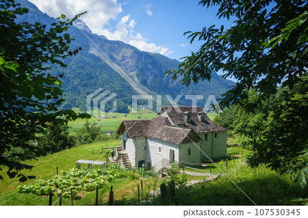 idyllic farmhouse in the swiss alps idyllic farmhouse in the swiss alps 107530345