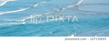 mild ocean water surface background with small waves near the beach mild ocean water surface background with small waves near the beach 107530695