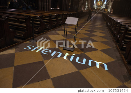 the word silentium projected on the floor of a church the word silentium projected on the floor of a church 107531454