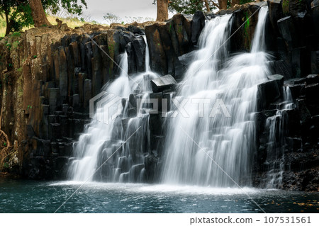 Scenic cascade waterfall with black rocks in Mauritius island 107531561