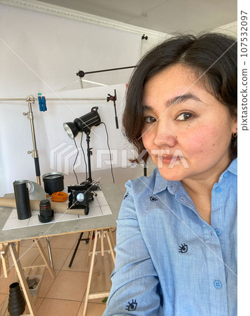 Snapshot of Passion: Asian Female Photographer Celebrates Equipment in Self-Portrait Snapshot of Passion: Asian Female Photographer Celebrates Equipment in Self-Portrait 107532097