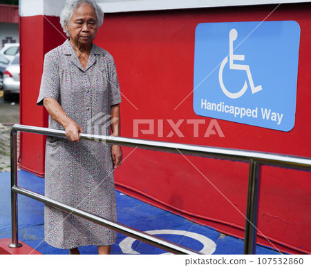 Asian elderly old woman patient use support rail on ramp, handrail safety grab bar, security in nursing hospital. Asian elderly old woman patient use support rail on ramp, handrail safety grab bar, security in nursing hospital. 107532860