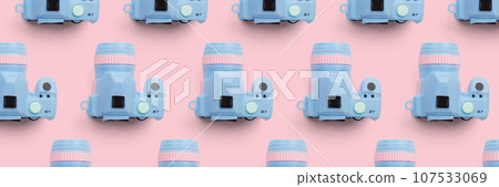 Pattern with SLR camera on pastel color background 107533069