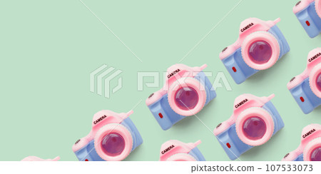 Pattern with SLR camera on pastel color background 107533073