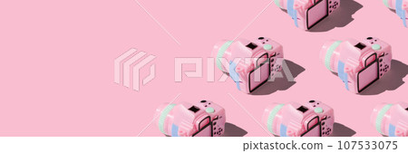 Pattern with SLR camera on pastel color background 107533075
