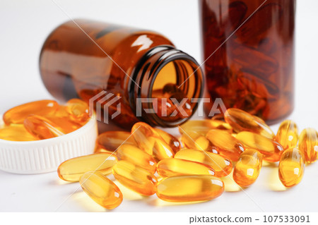 Fish oil or Cod liver oil gel in capsules with omega 3 vitamins, supplementary healthy food 107533091