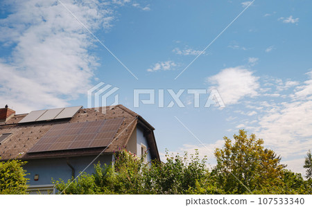 Solar photovoltaic panels on house roof. Modern country house with self-sustaining energy system. Suburb of Vienna, Austria. Idea harnessing clean and sustainable energy, saving money on electricity Solar photovoltaic panels on house roof. Modern country house with self-sustaining energy system. Suburb of Vienna, Austria. Idea harnessing clean and sustainable energy, saving money on electricity 107533340