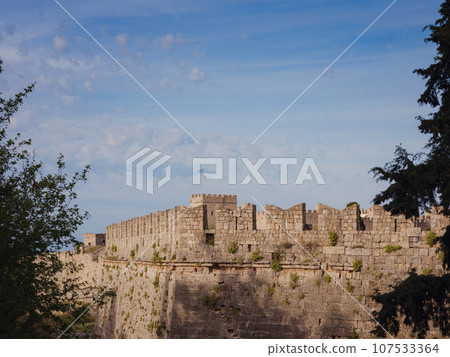 Travel to Greece, Mediterranean islands Rhodes. The walls of the medieval city of Rhodes, fortified stone walls of the fortification defense system of the old city. Travel to Greece, Mediterranean islands Rhodes. The walls of the medieval city of Rhodes, fortified stone walls of the fortification defense system of the old city. 107533364