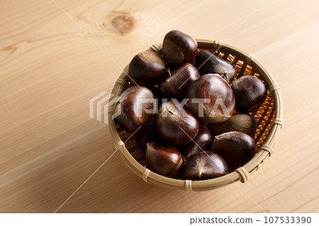 A bamboo basket full of chestnuts A bamboo basket full of chestnuts 107533390