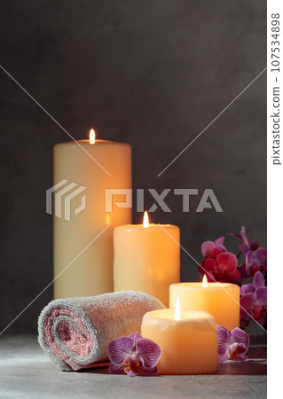 Towels, orchid flowers, and burning candles. Towels, orchid flowers, and burning candles. 107534898