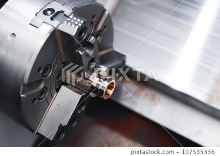 Automated CNC machine processes brass workpiece. Making a bronze bushing. Industrial production video Automated CNC machine processes brass workpiece. Making a bronze bushing. Industrial production video 107535336