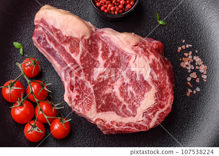 Fresh juicy raw beef striploin steak with salt and spices 107538224