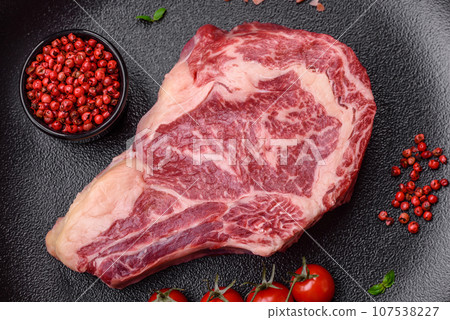 Fresh juicy raw beef striploin steak with salt and spices Fresh juicy raw beef striploin steak with salt and spices 107538227