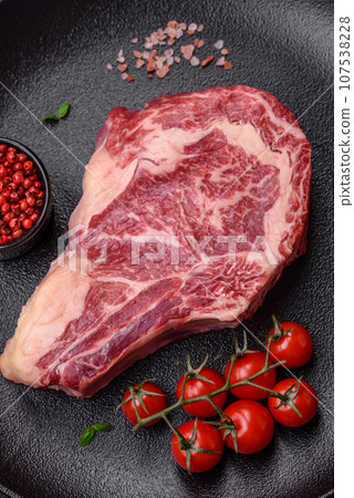 Fresh juicy raw beef striploin steak with salt and spices Fresh juicy raw beef striploin steak with salt and spices 107538228