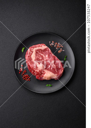 Fresh juicy raw beef striploin steak with salt and spices Fresh juicy raw beef striploin steak with salt and spices 107538247