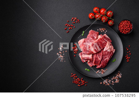 Fresh juicy raw beef slices with salt and spices 107538295